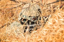 Airman 1st Class Santosh Gering, 791st Missile Security Forces Squadron convoy response force member, looks for opposing force during a tactical training exercise in Garrison, N.D., March 26, 2015. The force on force exercise used “simunition” rounds, which allows defenders to safely train and fire weapons at opposing forces. (U.S. Air Force photo/Airman 1st Class Apryl Hall)