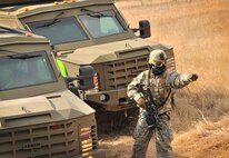 Senior Airman Michael Tyler, 791st Missile Security Forces Squadron convoy response force member, directs a fellow defender during a tactical training exercise in Garrison, N.D., March 26, 2015. The purpose of the week-long training was to prepare the CRF team for Road Warrior Exercise, an Air Force Global Strike Command exercise scheduled for May. (U.S. Air Force photo/Airman 1st Class Apryl Hall)