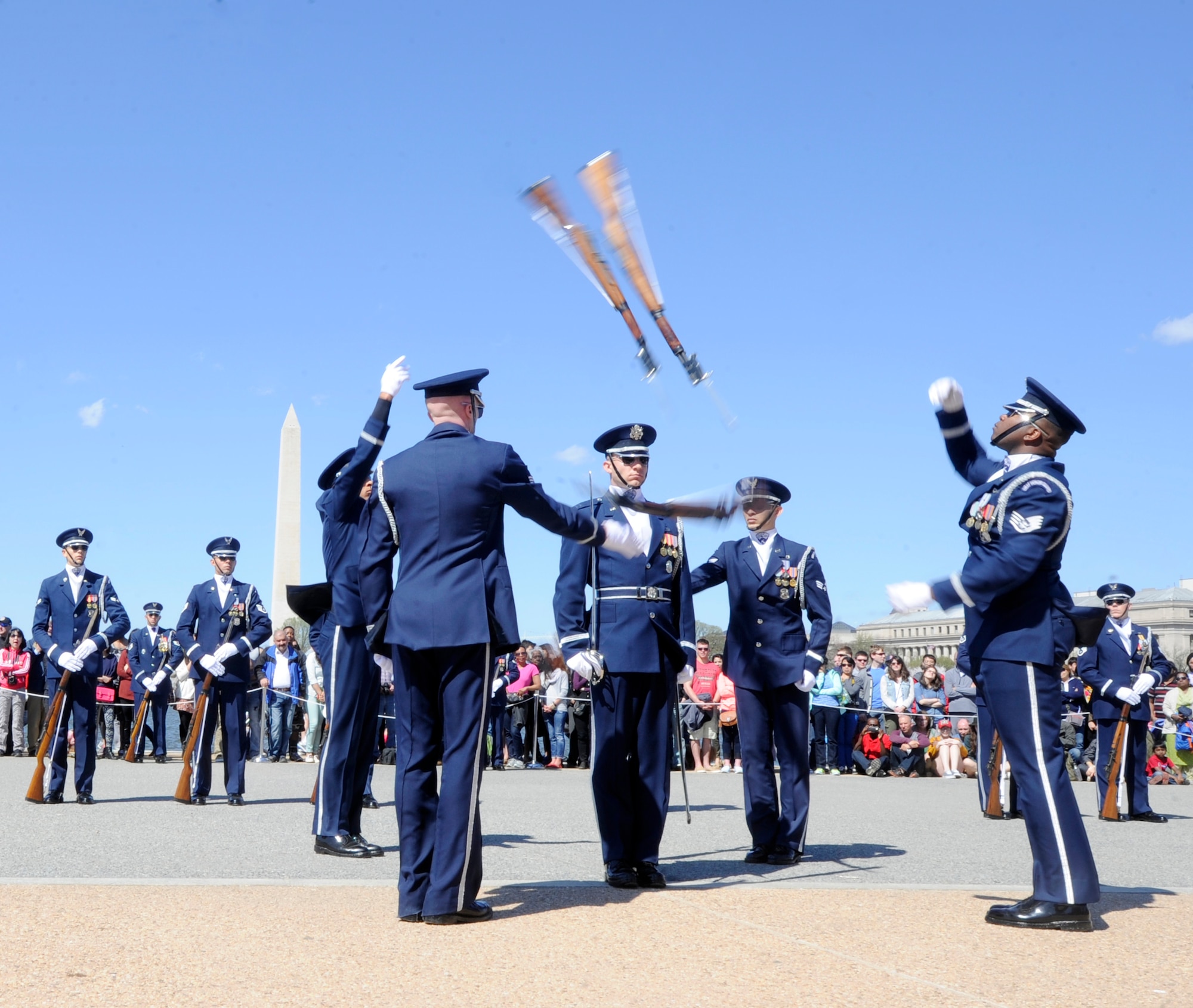 The United Stated Air Force Honor Guard four-man team throws their rifles in the air at the Joint Service Drill Exhibition in Washington, D.C., April 11, 2015. The Old Guard, Army, Navy, Marines, Coast Guard and Naval Academy’s drill team also performed during the event. (U.S. Air Force photo/Airman 1st Class Ryan J. Sonnier)