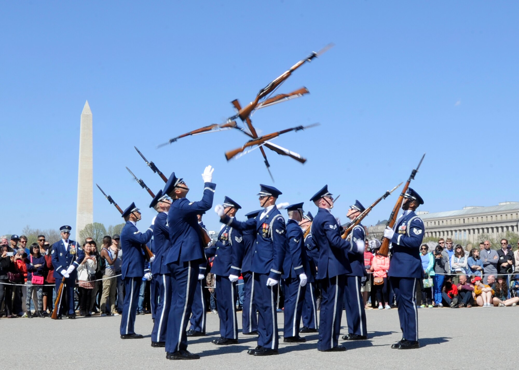 The United States Air Force Honor Guard tosses their rifles through the air during the Joint Service Drill Exhibition in Washington, D.C., April 11, 2015. The Old Guard, Army, Navy, Marines, Coast Guard and Naval Academy’s drill team also performed during the event. (U.S. Air Force photo/Airman 1st Class Ryan J. Sonnier)