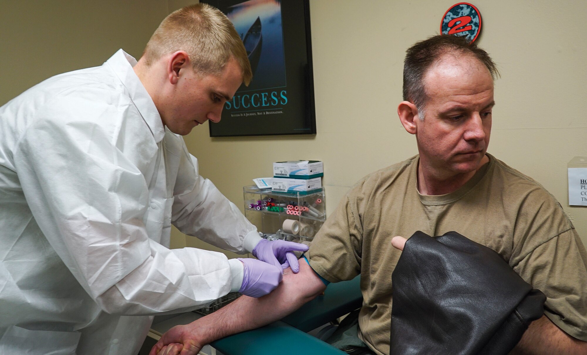WRIGHT-PATTERSON AIR FORCE BASE, Ohio - Staff Sgt. Logan McKinney, a medical laboratory technician with the 445th Aerospace Medicine Squadron, draws blood from Lt. Col. Richard Klarich, 89th Airlift Squadron pilot. Other parts of the assessment involve optometry, lab testing, immunizations and general counseling. ((U.S. Air Force photo/Senior Airman Devin Long)