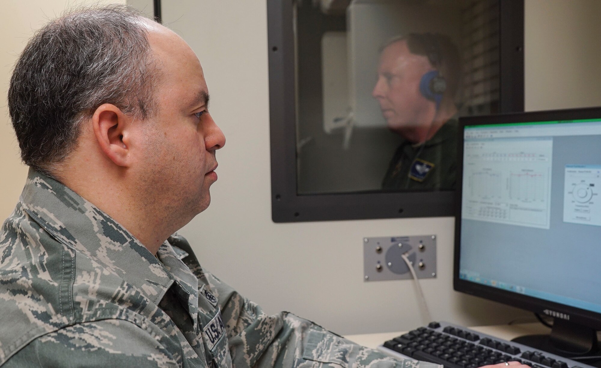WRIGHT-PATTERSON AIR FORCE BASE, Ohio - Staff Sgt. Omar Reyes, 445th Aerospace Medicine Squadron public health technician, performs a hearing test on a patient at the Wright-Patterson Air Force Base Medical Center March 7, 2015. The hearing test is part of the annual physical health assessment. (U.S. Air Force photo/Senior Airman Devin Long)
