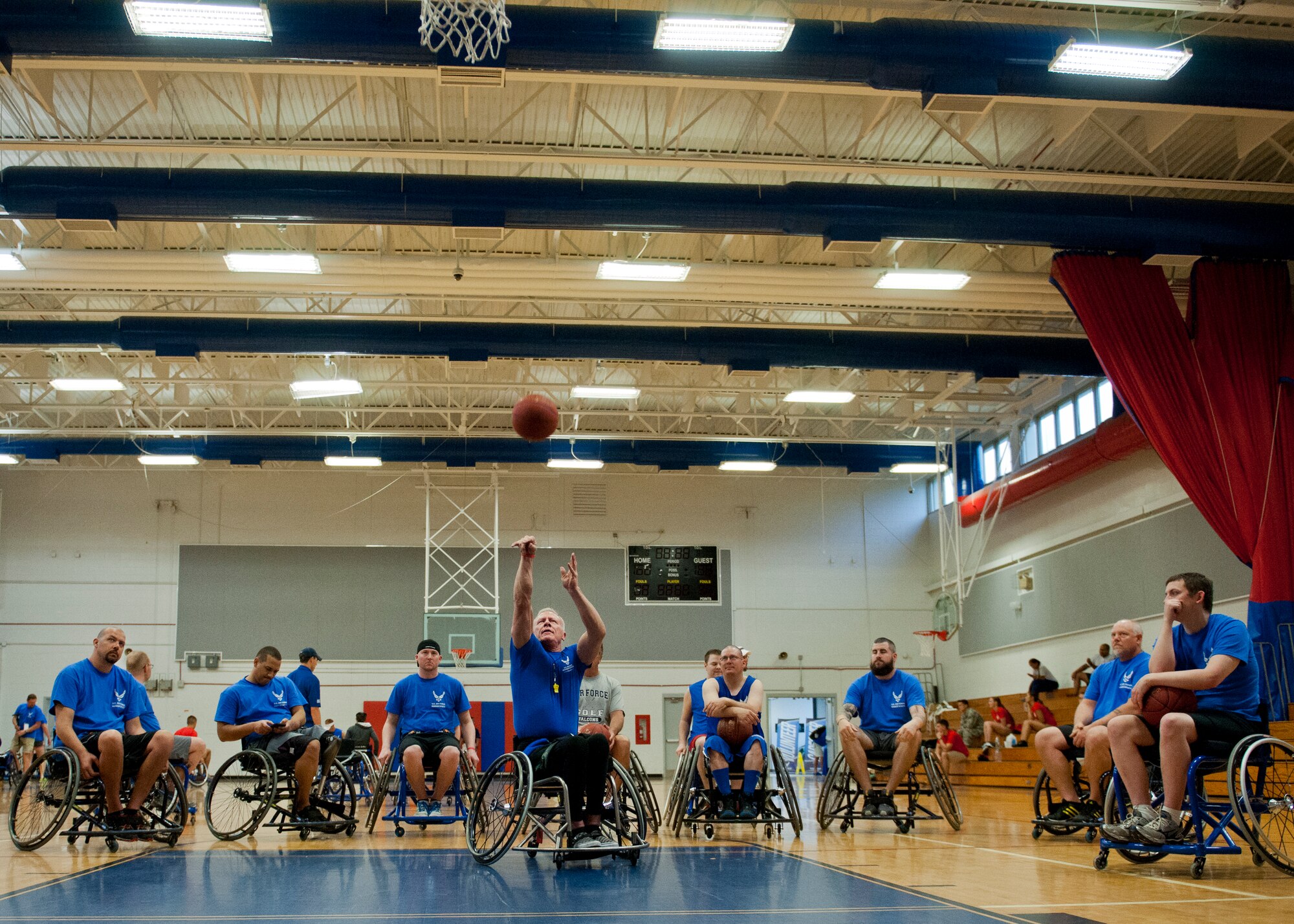 Mark Shepherd, an Air Force Wounded Warrior coach, demonstrates wheelchair basketball during the first day of an introductory adaptive sports and rehabilitation camp at Eglin Air Force Base, Fla., April 13. The DOD’s military adaptive sports program enhances warrior recovery by engaging wounded, ill and injured service members in ongoing, daily adaptive activities, based on their interest and ability.  (U.S. Air Force photo/Samuel King Jr.)