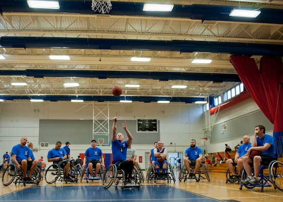 Mark Shepherd, an Air Force Wounded Warrior coach, demonstrates wheelchair basketball during the first day of an introductory adaptive sports and rehabilitation camp at Eglin Air Force Base, Fla., April 13. The DOD’s military adaptive sports program enhances warrior recovery by engaging wounded, ill and injured service members in ongoing, daily adaptive activities, based on their interest and ability.  (U.S. Air Force photo/Samuel King Jr.)