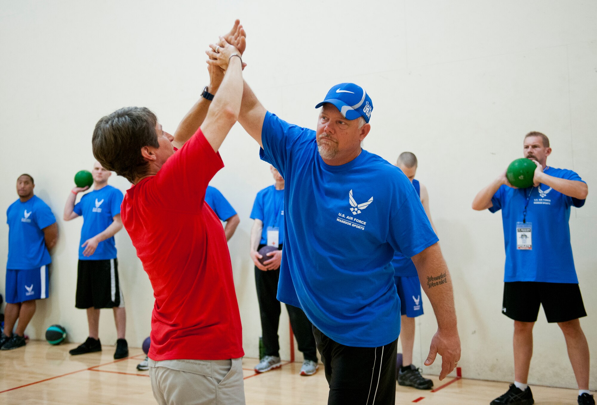 Erica Wheeler, an Air Force Wounded Warrior coach, helps Tim Wymore with his throwing technique during the first day of an introductory adaptive sports and rehabilitation camp at Eglin Air Force Base, Fla., April 13. The DOD’s military adaptive sports program enhances warrior recovery by engaging wounded, ill and injured service members in ongoing, daily adaptive activities, based on their interest and ability.  (U.S. Air Force photo/Samuel King Jr.)
