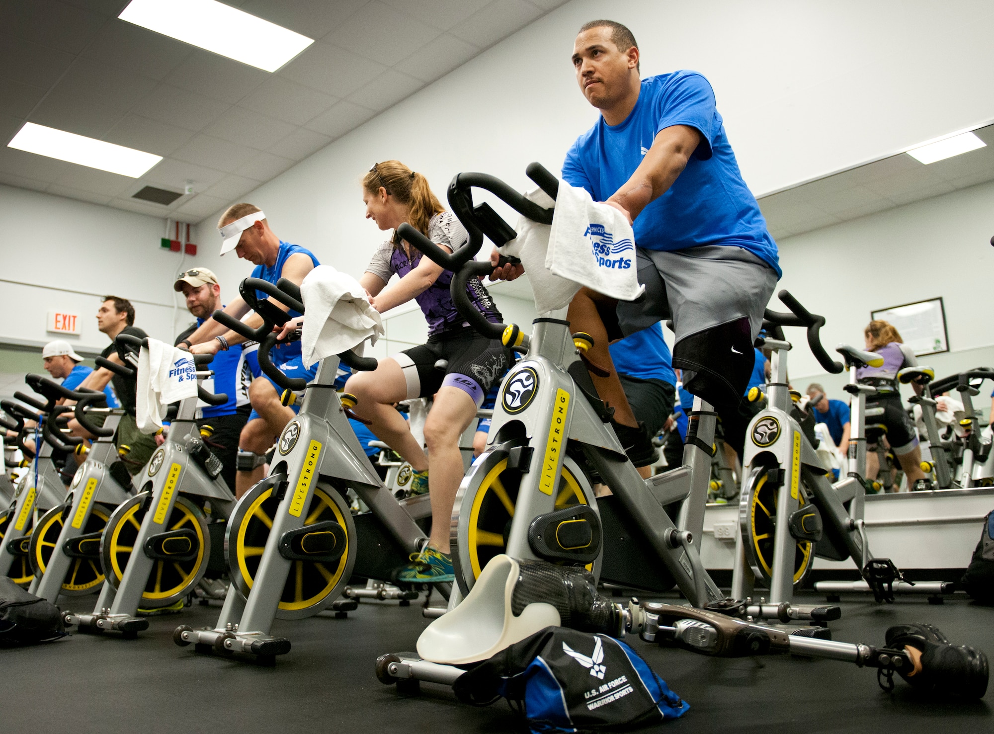 A group of Air Force Wounded Warrior athletes and mentors peddle through a spin class during the first day of an introductory adaptive sports and rehabilitation camp at Eglin Air Force Base, Fla., April 13. The DOD’s military adaptive sports program enhances warrior recovery by engaging wounded, ill and injured service members in ongoing, daily adaptive activities, based on their interest and ability.  (U.S. Air Force photo/Samuel King Jr.)
