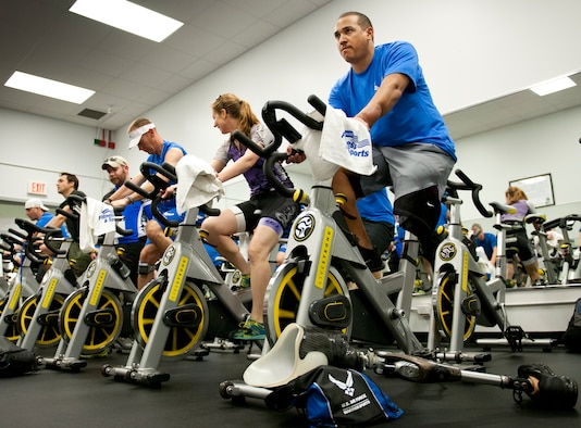 A group of Air Force Wounded Warrior athletes and mentors peddle through a spin class during the first day of an introductory adaptive sports and rehabilitation camp at Eglin Air Force Base, Fla., April 13. The DOD’s military adaptive sports program enhances warrior recovery by engaging wounded, ill and injured service members in ongoing, daily adaptive activities, based on their interest and ability.  (U.S. Air Force photo/Samuel King Jr.)