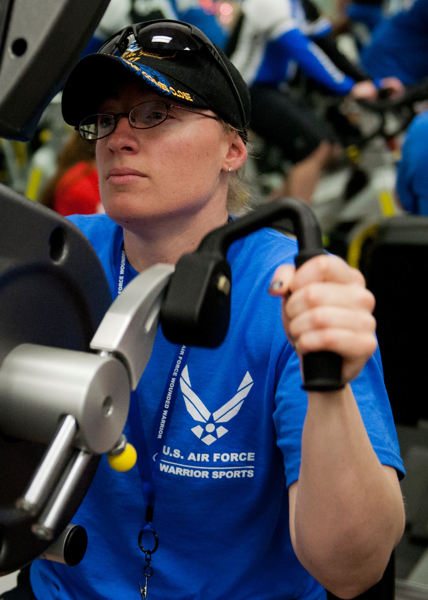 Melissa Gonzales, an Air Force Wounded Warrior athlete, peddles a stationary bike with her arms during the first day of an introductory adaptive sports and rehabilitation camp at Eglin Air Force Base, Fla., April 13. The DOD’s military adaptive sports program enhances warrior recovery by engaging wounded, ill and injured service members in ongoing, daily adaptive activities, based on their interest and ability.  (U.S. Air Force photo/Samuel King Jr.)