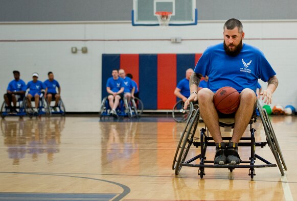 Jarrett Cox, an Air Force Wounded Warrior athlete, learns to handle a basketball while moving in a wheelchair during the first day of an introductory adaptive sports and rehabilitation camp at Eglin Air Force Base, Fla., April 13. The DOD’s military adaptive sports program enhances warrior recovery by engaging wounded, ill and injured service members in ongoing, daily adaptive activities, based on their interest and ability.  (U.S. Air Force photo/Samuel King Jr.)