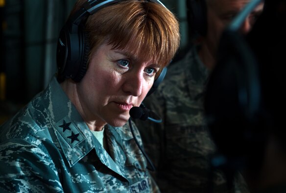 Maj. Gen. Dorothy A. Hogg , director, Medical Operations and Research Office of the Surgeon General, Headquarters U.S. Air Force, listens to a flight nurse from the 86th Aeromedical Evacuation Squadron March 26, 2015, above Ramstein Air Base, Germany. Hogg observed members of the 86th AES and Tactical Critical Care Evacuation Team -  Enhanced during a training flight on board a C-130J Super Hercules from the 37th Airlift Squadron. (U.S. Air Force photo/Staff Sgt. Sara Keller)