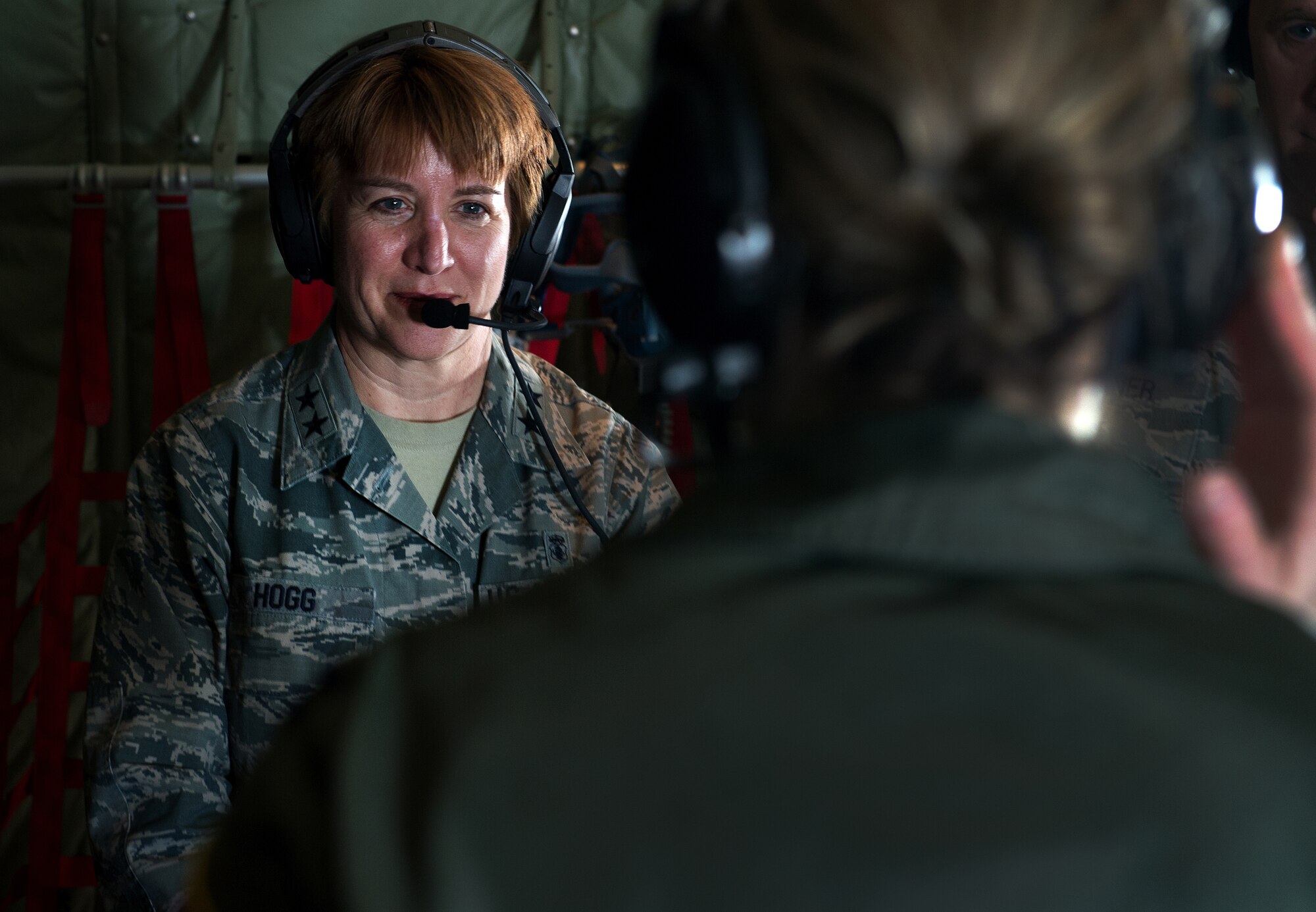 Maj. Gen. Dorothy A. Hogg , director, Medical Operations and Research Office of the Surgeon General, Headquarters U.S. Air Force, listens to a flight nurse from the 86th Aeromedical Evacuation Squadron March 26, 2015, above Ramstein Air Base, Germany. Hogg observed members of the 86th AES and Tactical Critical Care Evacuation Team -  Enhanced during a training flight on board a C-130J Super Hercules from the 37th Airlift Squadron. (U.S. Air Force photo/Staff Sgt. Sara Keller)