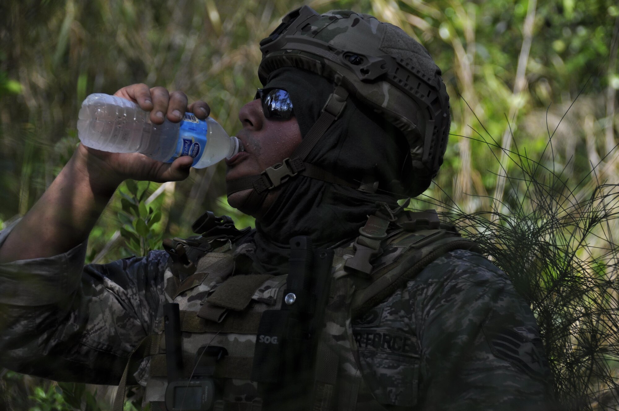 Staff Sgt. Fernando Olivas-Fortin, 482nd Civil Engineering Squadron Explosive Ordnance Disposal team member takes a short break from dismounted Counter Improvised Explosive Device operation to hydrate. This training was designed to give EOD Airmen firsthand experience dealing with IEDs when robotic means aren't feasible; it entailed classroom lessons, practical exercises, dismounted operations, and a task oriented physical exercise.  (U.S. Air Force photo by Senior Airman Aja Heiden)