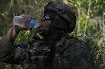 Staff Sgt. Fernando Olivas-Fortin, 482nd Civil Engineering Squadron Explosive Ordnance Disposal team member takes a short break from dismounted Counter Improvised Explosive Device operation to hydrate. This training was designed to give EOD Airmen firsthand experience dealing with IEDs when robotic means aren't feasible; it entailed classroom lessons, practical exercises, dismounted operations, and a task oriented physical exercise.  (U.S. Air Force photo by Senior Airman Aja Heiden)