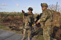 Staff Sgt. Jason Cohen, 482nd Civil Engineering Squadron Explosive Ordnance Disposal team member, showed Staff Sgt. Fernando Olivas-Fortin, 482nd CES EOD team member where a suspected Improvised Explosive Device was located as they participated in Counter Improvised Explosive Device training at Homestead Air Reserve Base, Fla. April 7. This week-long training entailed classroom lessons, practical exercises, dismounted operations, and a task oriented physical exercise which was designed by team leaders to give Reserve Airmen firsthand experience dealing with IEDs when robotic means aren't feasible. (U.S. Air Force photo by Senior Airman Aja Heiden)