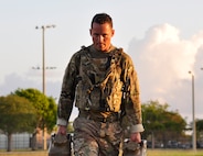 Tech. Sgt. Aaron Johns, Explosive Ordnance Disposal team leader for 482nd Civil Engineering Squadron, carries roughly 80 pounds of water 100 meters at Homestead Air Reserve Base, Fla., April 6. This was a part of the task oriented physical exercise which consisted of a 3 mile ruck, which included jumping over a six foot wall, and carrying roughly 80 pounds of water 100 meters designed to test physical stamina all completed in less than 75 minutes. (U.S. Air Force photo by Senior Airman Aja Heiden)