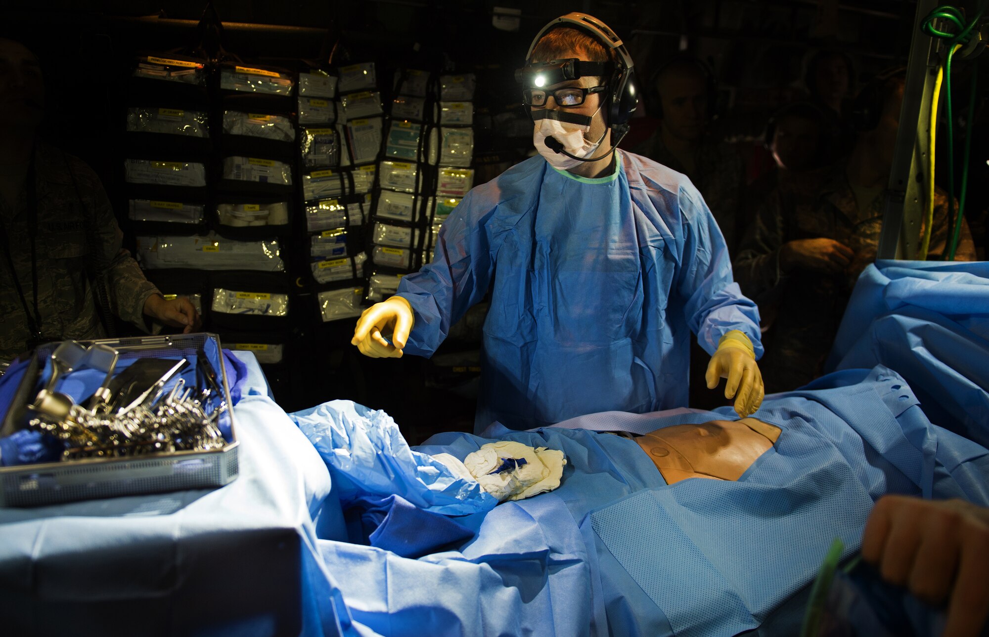 Capt. Dallas Hansen, an 86th Medical Squadron surgeon with Tactical Critical Care Evacuation Team - Enhanced, known as “TCCET-E” for short, performs a mock in-flight surgery during a training flight with the 86th Aeromedical Evacuation Squadron March 26, 2015, above Ramstein Air Base, Germany. The exercise scenario was performed on board a 37th Airlift Squadron C-130J Super Hercules to help perfect the potentially new TCCET-E capability which gives the 86th AES and flight surgeons the ability to do quick, critical surgeries as fast as possible while in transit to a hospital. (U.S. Air Force photo/Staff Sgt. Sara Keller) 