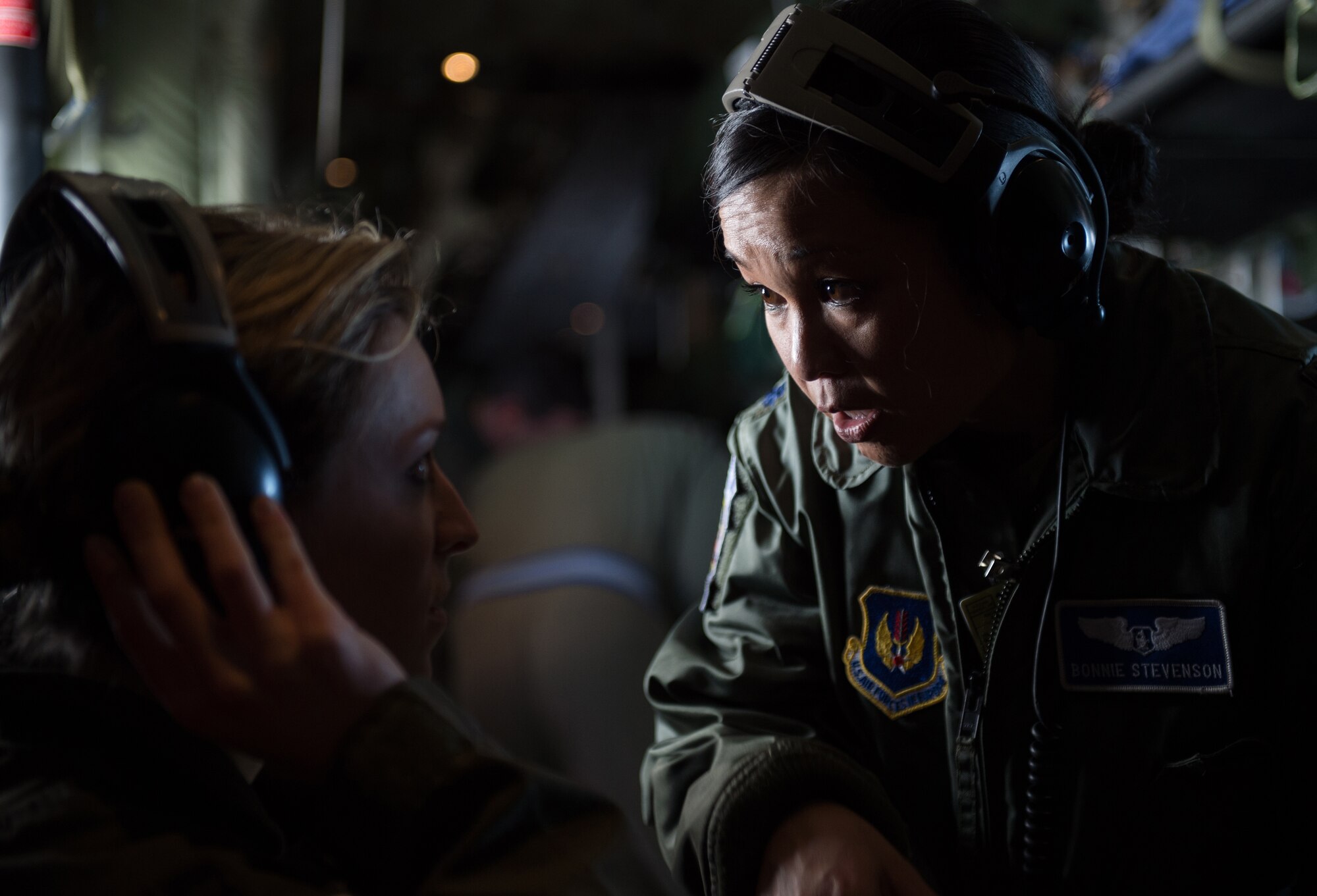 Lt. Col. Bonnie Stevenson, 86th Aeromedical Evacuation Squadron chief flight nurse, speaks with a fellow 86th AES teammate during a training flight with the Tactical Critical Care Evacuation Team — Enhanced, known as “TCCET-E”, March 26, 2015, above Ramstein Air Base, Germany. The 86th AES is responsible for providing aeromedical evacuation for U.S. troops throughout U.S. Air Forces in Europe and Air Forces Africa's area of responsibility and operate in a multitude of air frames and conditions. (U.S. Air Force photo/Staff Sgt. Sara Keller)