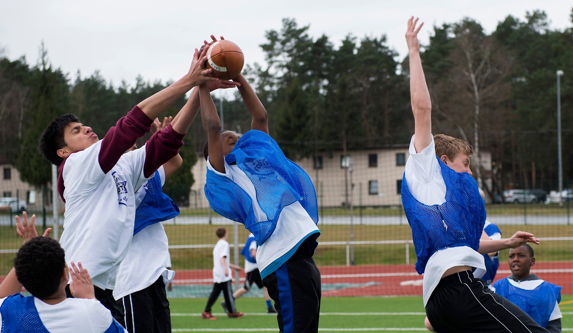 Darrick Henderson Jr., center, son of Zachary Warren, intercepts a pass April 11, at Vogelweh Military Complex, Germany. During the camp, attendees learned the fundamentals of football through drills, skill development, seven-on-seven games and interactions with local coaches. (U.S. Air Force photo/Senior Airman Damon Kasberg)
