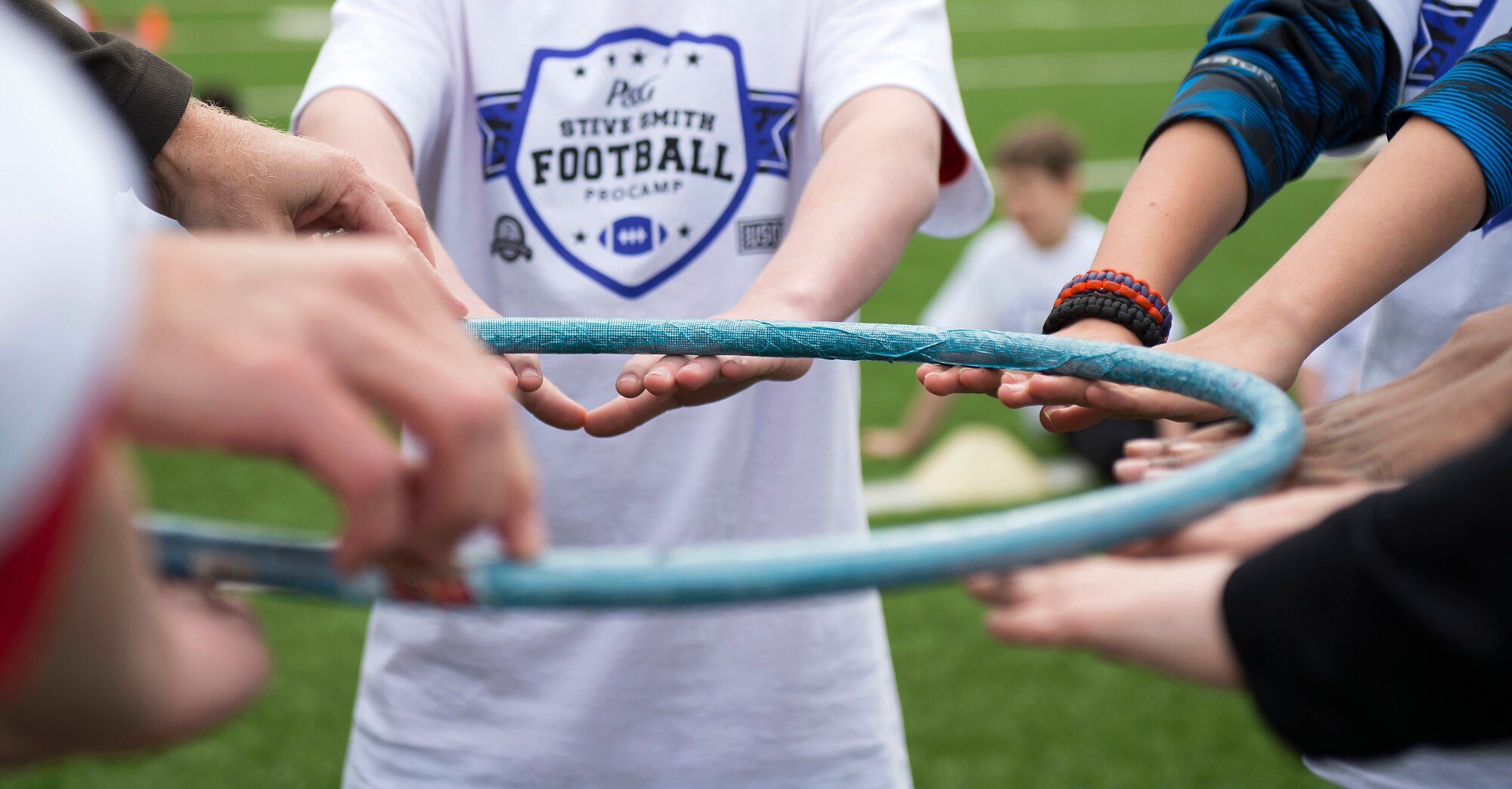 Children participate in a team building exercise during a ProCamps event April 11, 2015, at Vogelweh Military Complex, Germany. Attendees of the camp had the opportunity to meet Steve Smith, Baltimore Ravens wide receiver, who demonstrated football techniques, autographed shirts and participated in scrimmages. (U.S. Air Force photo/Senior Airman Damon Kasberg)
