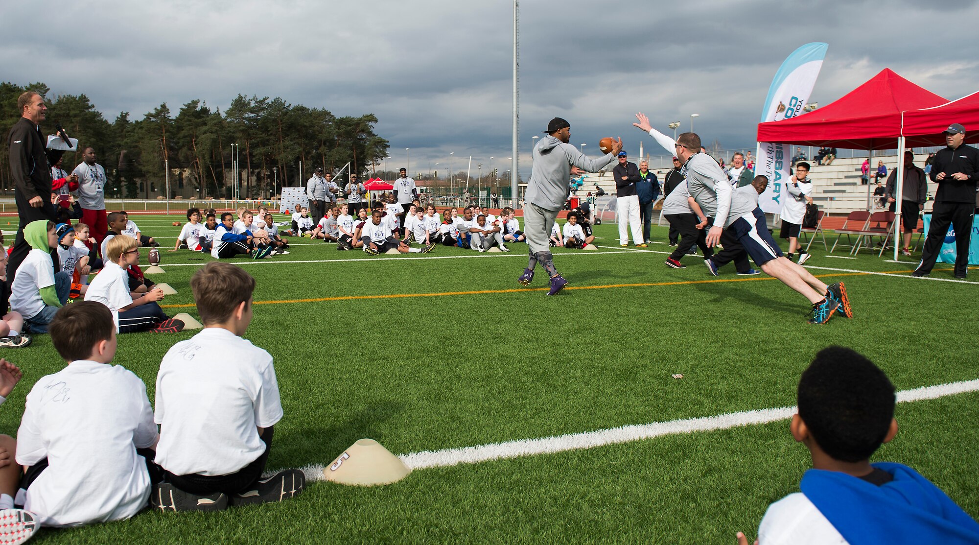 Tech. Sgt. Samuel Lewis, 786th Civil Engineer Squadron Prime Base Expeditionary Engineer Force NCO in charge, attempts to stop Steve Smith, Baltimore Ravens wide receiver, from catching a football April 11, 2015, at Vogelweh Military Complex, Germany. Lewis was assigned to guard the three-time All-Pro NFL wide receiver during a drill to show how the Ravens handle a blitz. (U.S. Air Force photo/Senior Airman Damon Kasberg)