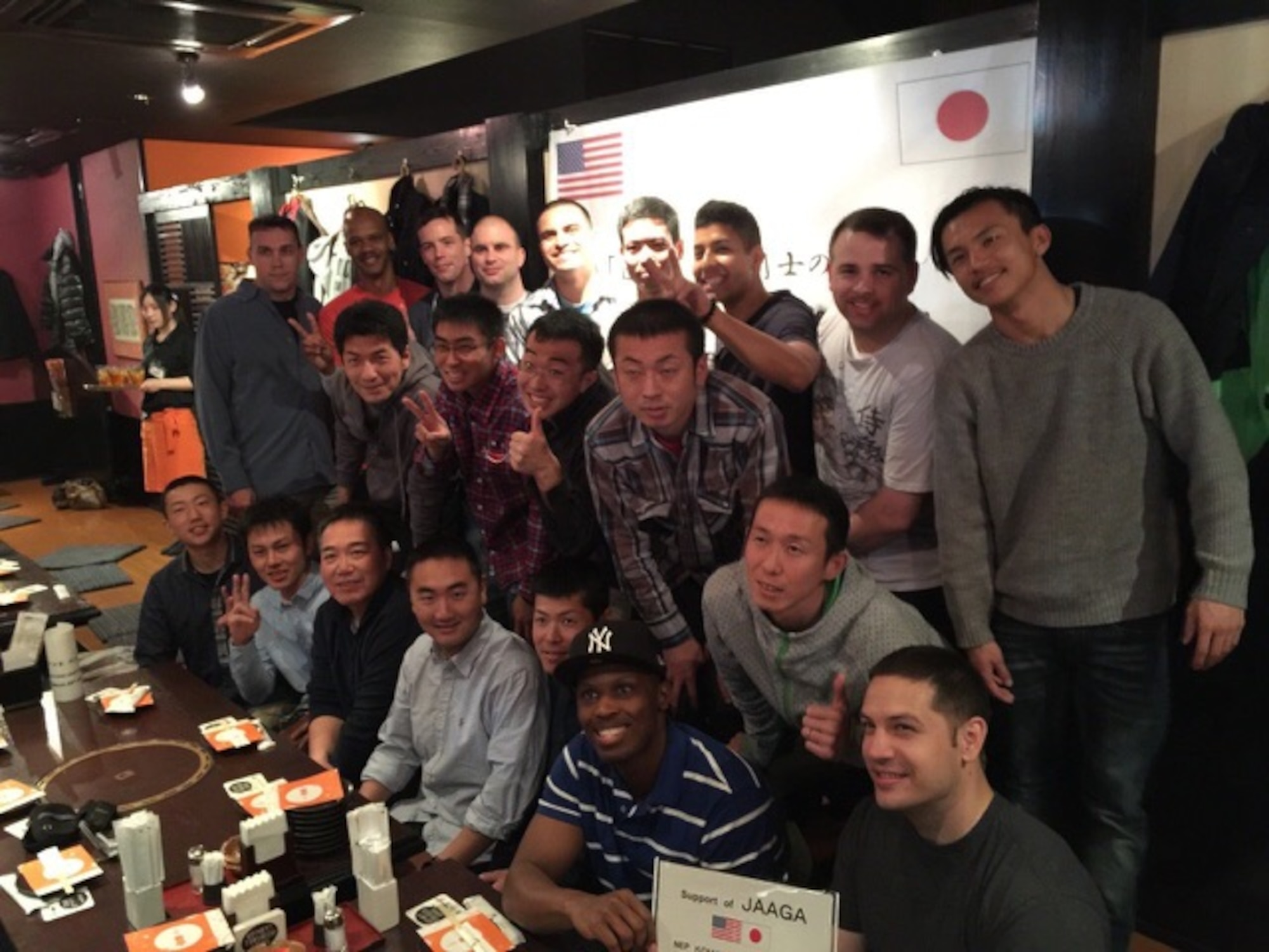 Yokota Airmen pose for a picture with Japan Air Self-Defense Force members at a restaurant during the noncommissioned officer exchange program at Komaki Air Base, Japan, March 23, 2015. Thirteen Airmen from Yokota stayed at Komaki Air Base for eight days and were able to experience the differences and similarities of U.S. and Japanese military life. (Courtesy photo)