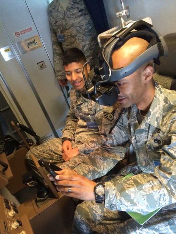 Staff Sgt. Bryan Bentley, 374th Operations Support Squadron (left), and Tech. Sgt. Terreil Reed, 730th Air Mobility Squadron, receive a lesson by Japan Air Self-Defense Force members on how to refuel aircraft in the air during the noncommissioned officer exchange program at Komaki Air Base, Japan, March 23, 2015. The device Reed has on allows him to see through a camera that is under the refueling aircraft. With the headset and the controls in his hand, Reed would be able to successfully refuel an aircraft with the proper training. (Courtesy photo)