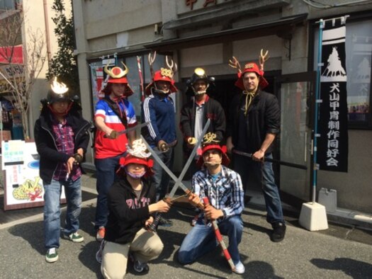 A Japan Air Self-Defense Force member (top left) poses with a group of Yokota Airmen at a samurai souvenir store during the noncommissioned officer exchange at Komaki Air Base, Japan, March 23, 2015. Thirteen NCOs from Yokota were able to participate in the exchange. (Courtesy photo)