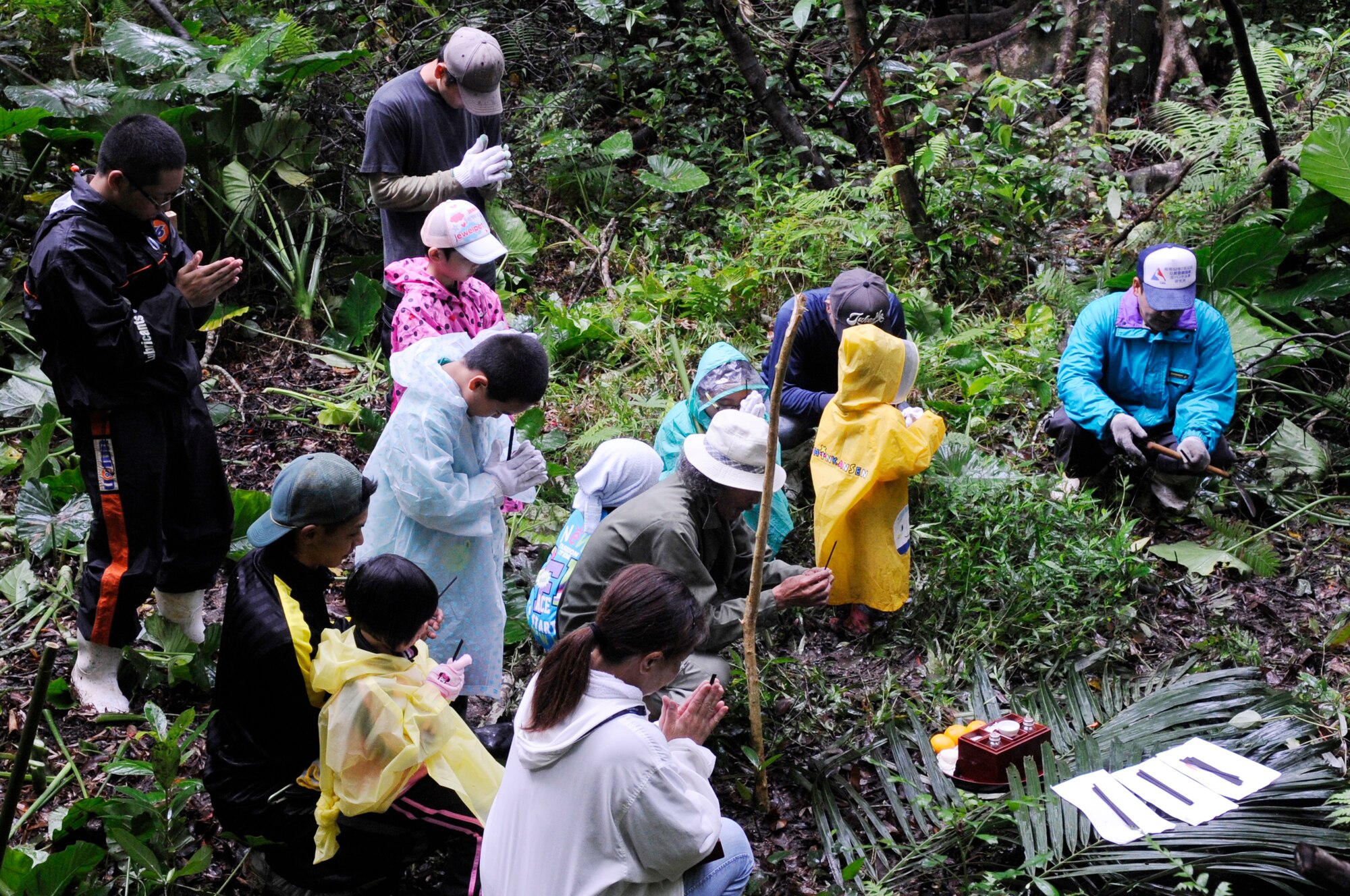 Local nationals and their families pray at their family tomb in observance of Shimi at the munitions storage area at Kadena Air Base, Japan, April 12, 2015. Shimi is an annual celebration on Okinawa, during which family tombs and the surrounding areas are cleaned before extended family members gather to pray and offer food to their ancestors. More than 400 locals visited the base this year to pray, eat and enjoy each other’s company. (U.S. Air Force photo by Staff Sgt. Marcus Morris)