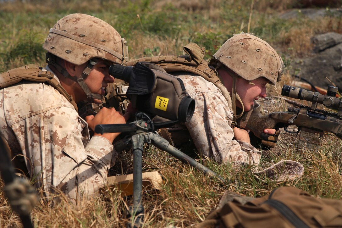 Marine Corps Cpls. Danny Villagomez, left, and Evan Taylor work as a ...