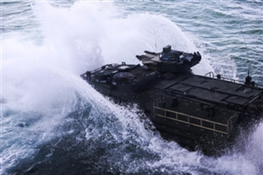An amphibious assault vehicle splashes from the well deck of the USS Kearsarge into the Atlantic Ocean, April 13, 2015. Marines used the amphibious assault vehicles as transportation to the shore of Onslow Beach, Camp Lejeune, N.C. More than 200 Marines simulated being part of a Marine Expeditionary Unit element deployed to conduct ship-to-shore assault.