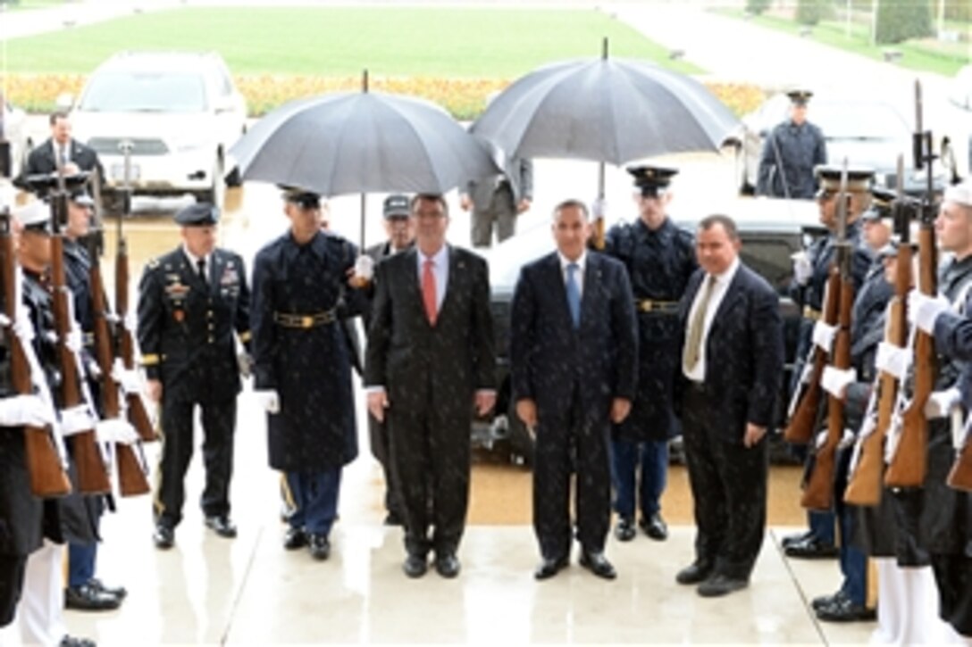 U.S. Defense Secretary Ash Carter, center left, hosts an honor cordon to welcome Iraqi Defense Minister Khalid al-Obeidi, center right, to the Pentagon, April 14, 2015.