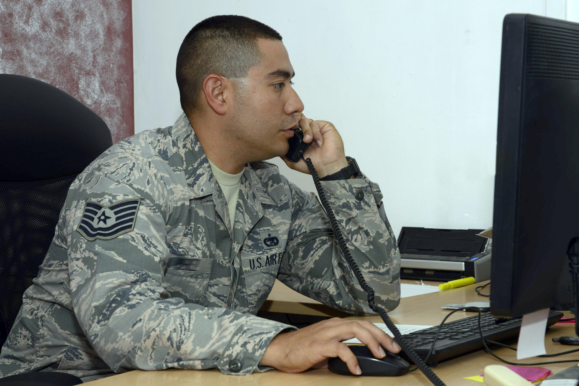 Tech. Sgt. Michael, passenger and personal property NCO in-charge, coordinates travel arrangements for an upcoming redeployment mission at an undisclosed location in Southwest Asia April 8, 2015. The traffic management office is responsible for managing aircraft and Patriot Express mission reservations as well as all commercial travel from aerial port of debarkation to home station. Michael is currently deployed from Fort Lee, Va. (U.S. Air Force photo/Tech. Sgt. Marie Brown/RELEASED)