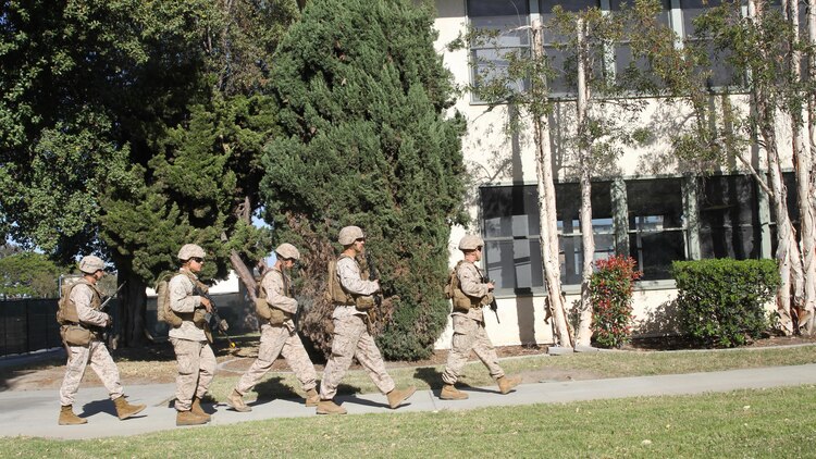 Marines from Company I, 3rd Battalion, 1st Marine Regiment file into a mock American Embassy during an embassy reinforcement training exercise on Joint Reserve Training Center Los Alamitos, Los Alamitos, California, April 11, 2015. The embassy reinforcement operation was a part of the 15th Marine Expeditionary Unit’s certification exercise, the last training exercise the MEU conducts before deployment.