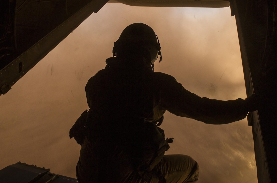 Lance Cpl. Paul Boley, a crew chief with Marine Operational Test and Evaluation Squadron 22, looks out the back of an MV-22B Osprey during a reduced visibility landing exercise aboard Kirtland Air Force Base, Albuquerque, New Mexico, April 2, 2015. During the flight, crew chiefs are the second pair of eyes for the pilot by helping them land and trouble-shoot potential problems. The crew chiefs are also responsible for maintaining and firing the aircraft’s weapons systems. (U.S. Marine Corps photo by Cpl. Andy J. Orozco/Released)
