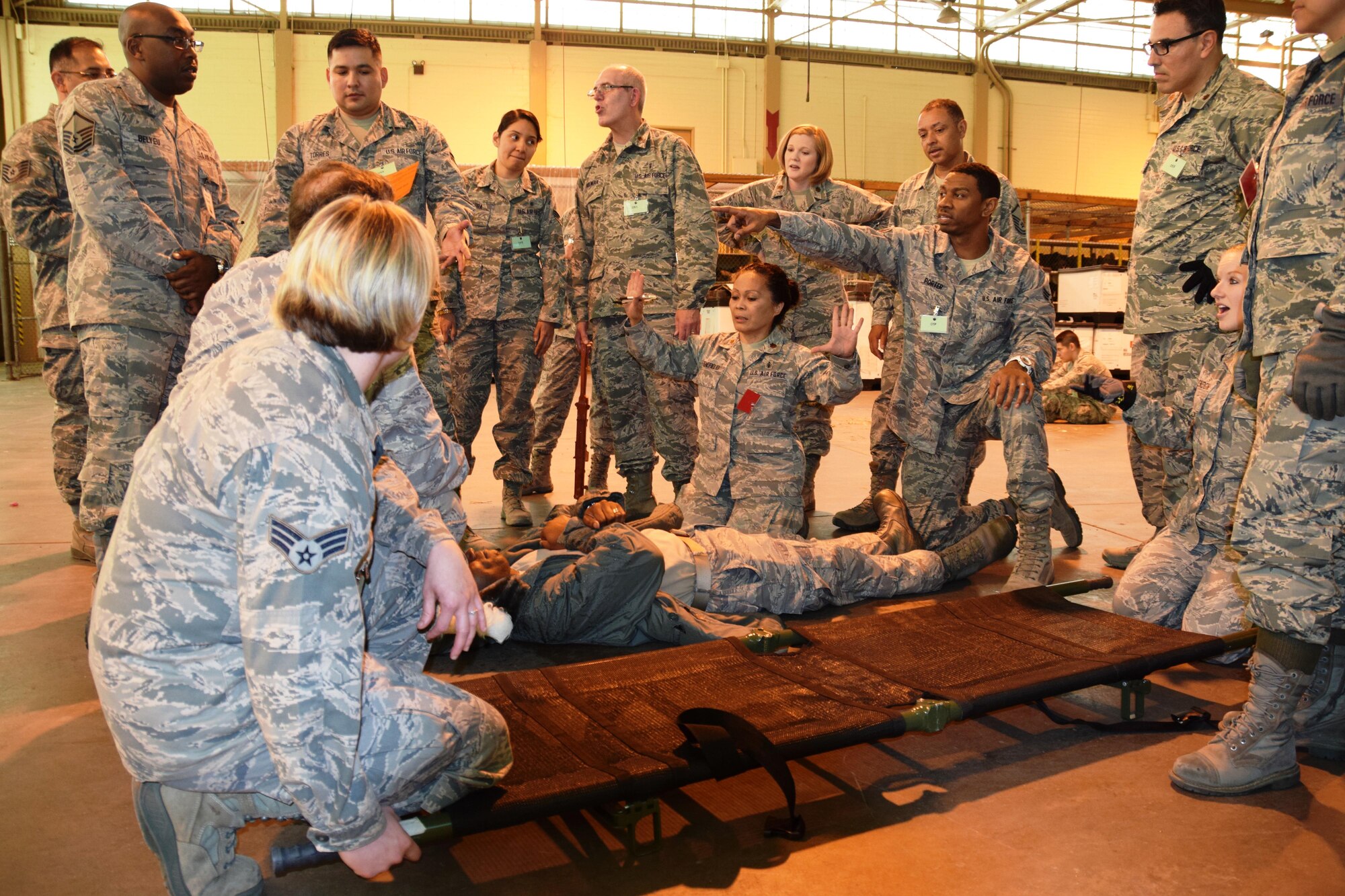 Maj. Julieta Benefield (center), a 433rd Medical Squadron clinical nurse, leads the treatment of a wounded suspect during an active shooter exercise at the Kelly Field Annex on Port San Antonio in San Antonio, Texas on April 11, 2015. (U.S. Air Force photo by Tech Sgt. Carlos J. Trevino)