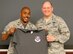 Col. Lloyd Terry, 960th Cyberspace Operations Group commander, presented Lieutenant General James F. Jackson, Air Force Reserve Command commander, a 960 CyOG unit morale t-shirt during his visit April 10 to the unit at Joint Base San Antonio-Lackland, Texas. The 960 CyOG provides combat-ready forces with specialized expertise, continuity and residency in the operations, defense and extension of Air Force and Department of Defense Global Information Grids in support of access to the global commons through Cyberspace for National Interests. (U.S. Air Force photo/Master Sgt. Josh Woods)