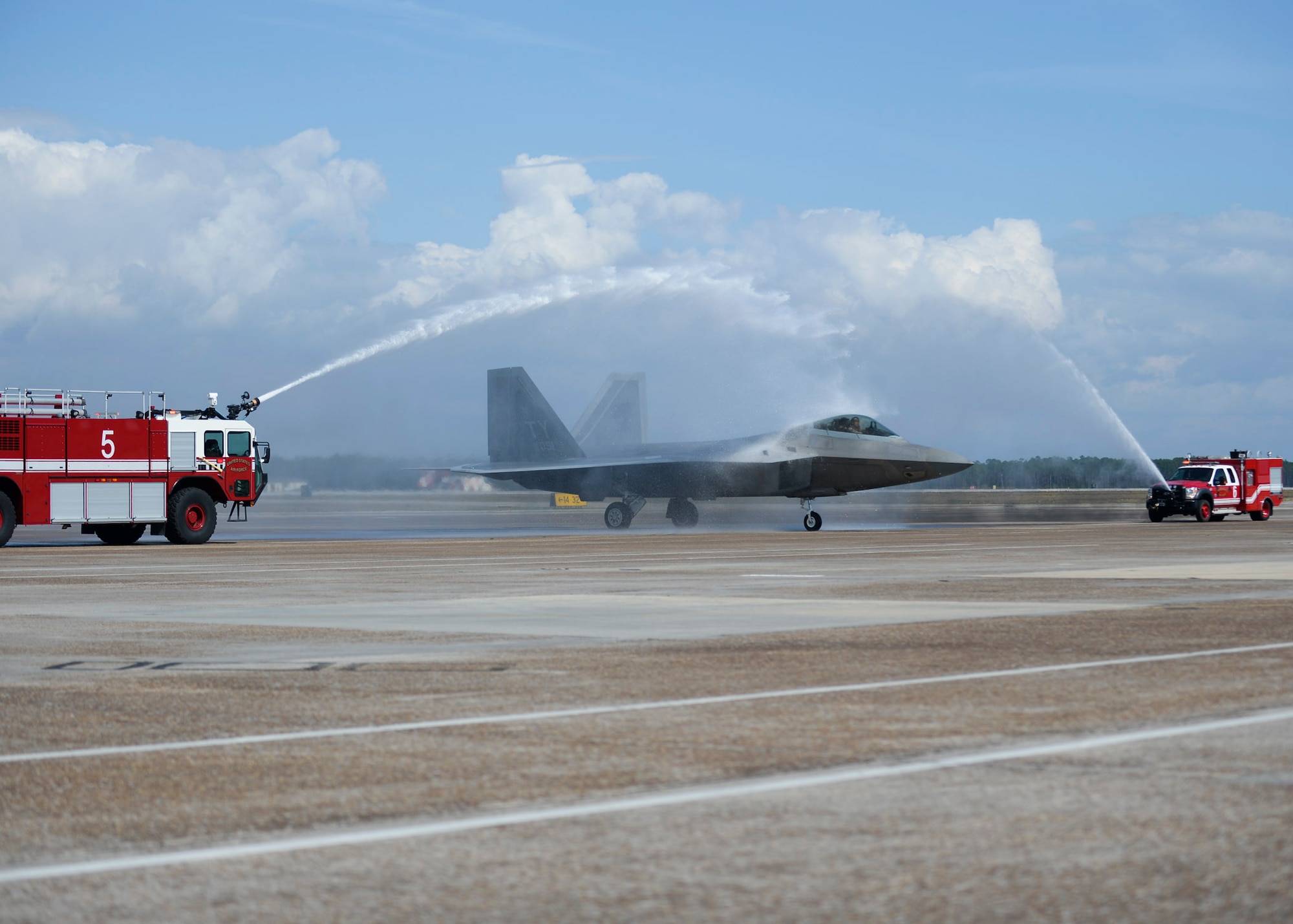 An F-22A Raptor taxis through streams of water March 25, 2015 at Tyndall Air Force Base, Fla., during a fini flight for Col. Scott Crogg, 44th Fighter Group commander. Crogg, an Air Force Academy graduate, led and flew over 140 combat missions throughout his 24-plus year career. Crogg, a command pilot with more than 3,300 flying hours in the F-16 and F-22, retires this month. The 44th Fighter Group is a geographical-separated unit within the 301st Fighter Wing. (U.S. Air Force photo by Airman 1st Class Dustin Mullen)