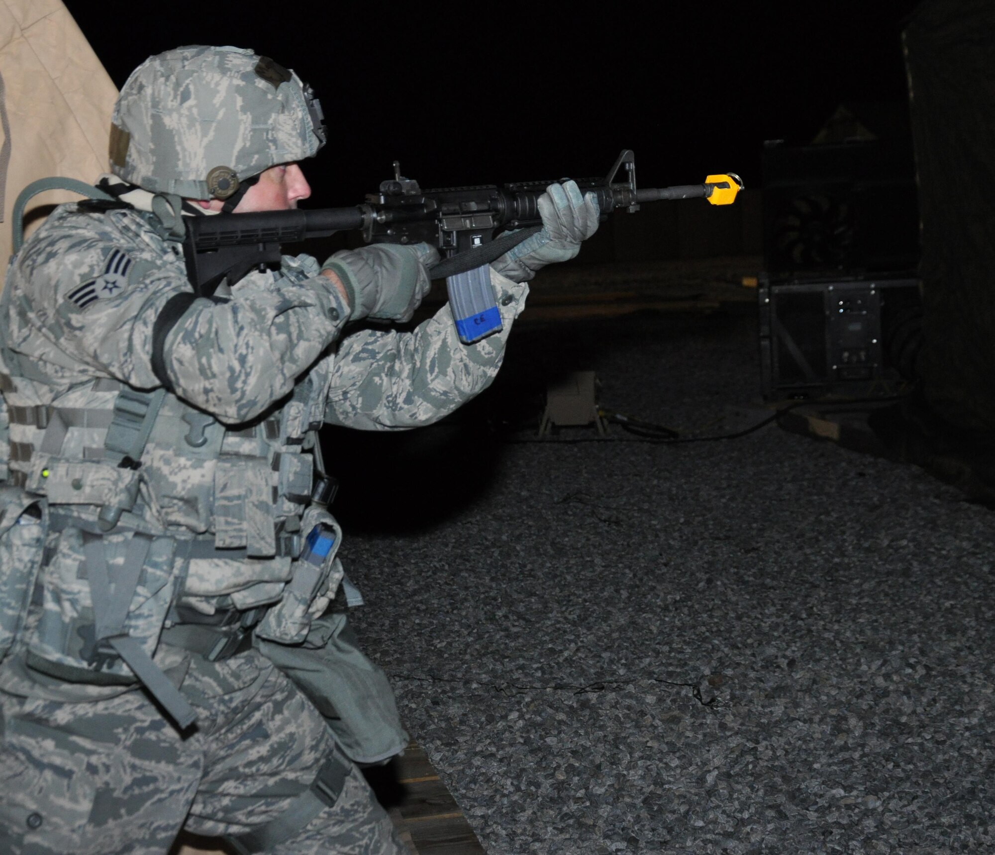 Senior Airman James Kirkpatrick, 301st Security Forces Squadron, holds a gun during an mission support group exercise March 6-7 in Fort Wolters, Texas. Nearly 140 Airmen from seven offices throughout the 301st Fighter Wing traveled through a personnel-processing line where Airmen carried out their duty-specific tasks in a simulated deployed environment. (U.S. Air Force photo/Capt. Candice Allen)