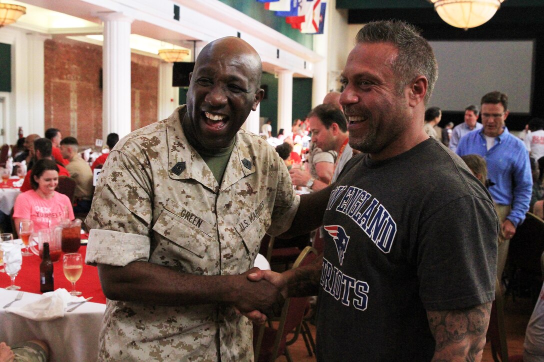 Sgt. Maj. Ronald Green shakes hands with Mark Giaquinto while posing for photographs during the family night dinner on April 9, Marine Corps Recruit Depot Parris Island, South Carolina. Giaquinto was in attendance as part of the Educators Workshop. The purpose of the workshop is to give the educators a firsthand look at how the Marine Corps transforms young men and women into United States Marines.  Green is the Sergeant Major of the Marine Corps. Giaquinto is an educator with North High School. (U.S. Marine Corps photo by Staff Sgt. Richard Blumenstein).