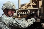 Army Spc. Grant Flegel moves the crane on the Heavy Expanded Mobile Tactical Truck (HEMTT) wrecker into place during training for the upcoming deployment with Delta Company, 3rd Battalion, 116th Cavalry Brigade Combat Team at the Gowen Field Training Area near Boise, Idaho, Aug. 28, 2010. This training helps cross-train the drivers of the HEMTT and the mechanics that service it, so the drivers will be better equipped to handle break-downs and towing procedures of this vehicle and others in a convoy.