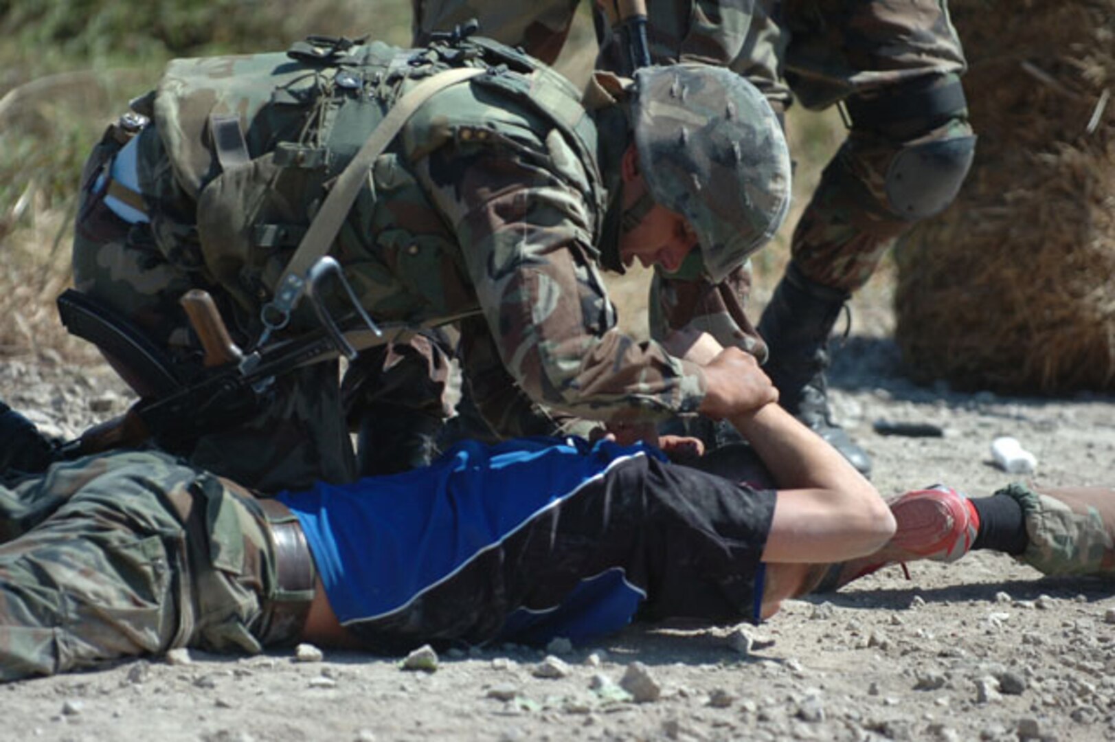 A Moldovan Soldier from Company A, 22nd Peacekeeping Battalion, takes a mock bandit into custody as part of an exercise designed to evaluate the unit's skills in international peacekeeping at Moldova's Bulboaca training facility, Aug. 19, 2010. For the past two weeks, North Carolina Army National Guard Soldiers have helped the Moldovans sharpen their peacekeeping skills in advance of a 2012 NATO evaluation.