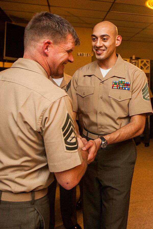 U.S. Marine Corps Staff Sgt. Fabio Patino, right, 22nd Marine Expeditionary Unit (MEU) administrative chief, congratulates Gunnery Sgt. Trevor Nelson, MEU logistics chief, after Nelson’s retirement ceremony at Veterans of Foreign Wars Post 9133 in Jacksonville, N.C., April 10, 2015. Nelson received a Meritorious Service Medal during the ceremony, retiring after 18 years of service. (U.S. Marine Corps photo by Sgt. Austin Hazard/Released)