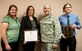 Tracy Bogdanovich, the 99th Medical Operations Squadron clinical research coordinator; Jill Clark, the 99th MDOS clinical research manager; Lt. Col. Paul Crawford, the 99th MDOS Clinical Investigation Program and Family Medicine Residency program director; and Aaron Barnett, the 99th MDOS clinical research coordinator, pose for a photo at the Mike O’Callaghan Federal Medical Center on Nellis Air Force Base, Nev., April 6, 2015. The CIP was presented with the Association of Military Surgeons of the United States 2014 Training and Education Award and the FMR was presented with the 2015 Outstanding Achievement in Scholarly Activity Award by the Uniformed Services Academy of Family Physicians. (U.S. Air Force photo/Airman 1st Class Mikaley Towle)