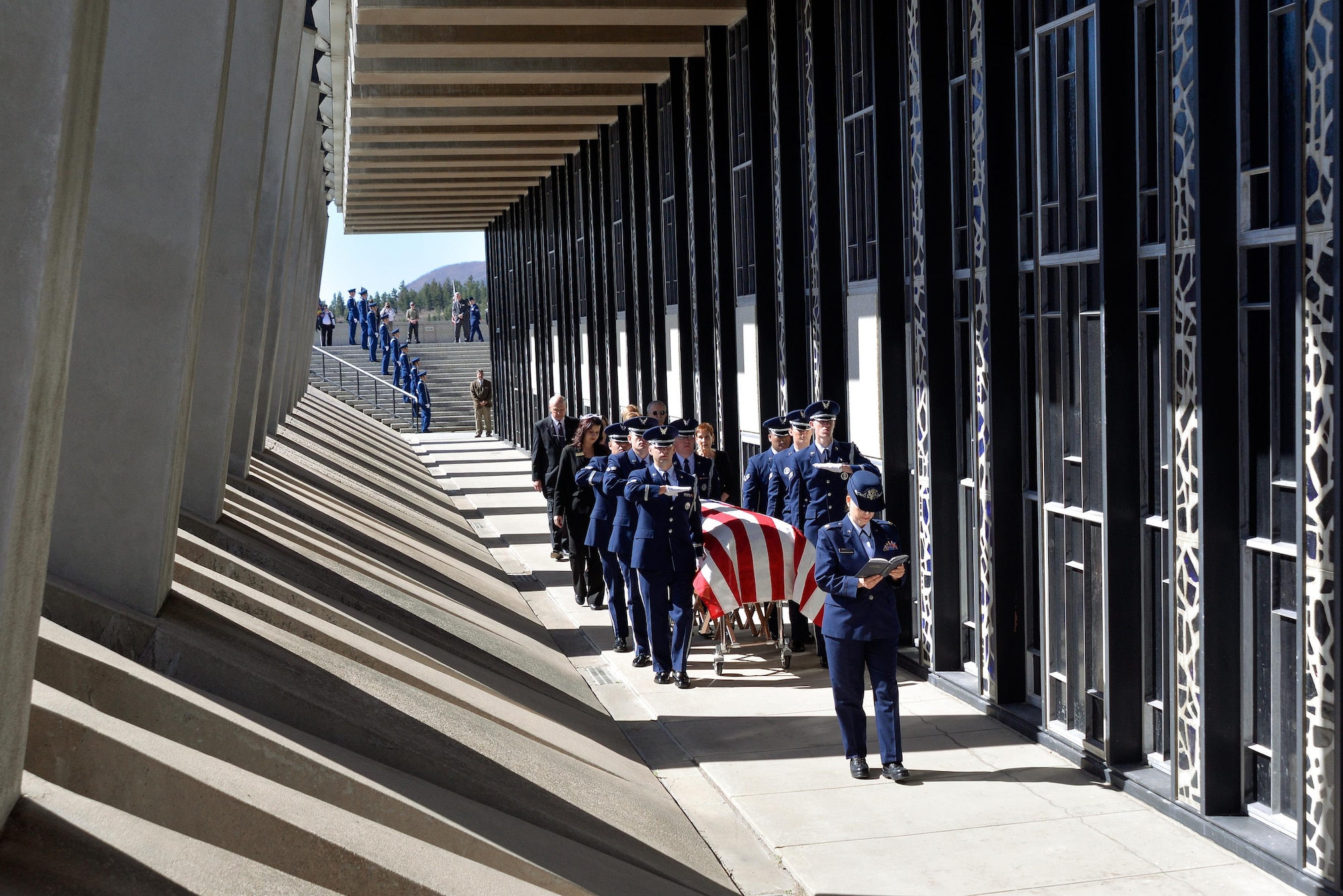 Rabbi (Maj.) Sarah Schechter, a Cadet Chapel Jewish chaplain, reads from the Torah while the honor guard escorts the casket containing the remains of Capt. Richard D. Chorlins, an Academy Class of ’67 graduate, into the Cadet Chapel at the U.S. Air Force Academy, Colo., April 14, 2015. Chorlins was killed in Vietnam in January 1970. His remains were transferred here April 13, 2015, in a dignified arrival ceremony and he was laid to rest at the Academy Cemetery April 14, 2015. (U.S. Air Force photo/Liz Copan)