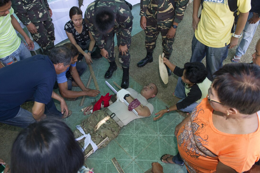 U.S. Army Spc. Neil Bautista, assigned to the 97th Civil Affairs Battalion, acts as a patient during first responder training in Tapaz, Philippines, during Balikatan 2015, April 14. The training was held for local health workers by U.S. and Armed Forces of the Philippines Army personnel as part of a Joint Civil-Military Operations Task Force on the island of Panay for the exercise. Balikatan, which means "shoulder to shoulder" in Filipino, is an annual bilateral training exercise aimed at improving the ability of the Philippine and U.S. military forces to work together during planning, contingency, humanitarian assistance and disaster relief operations. 
