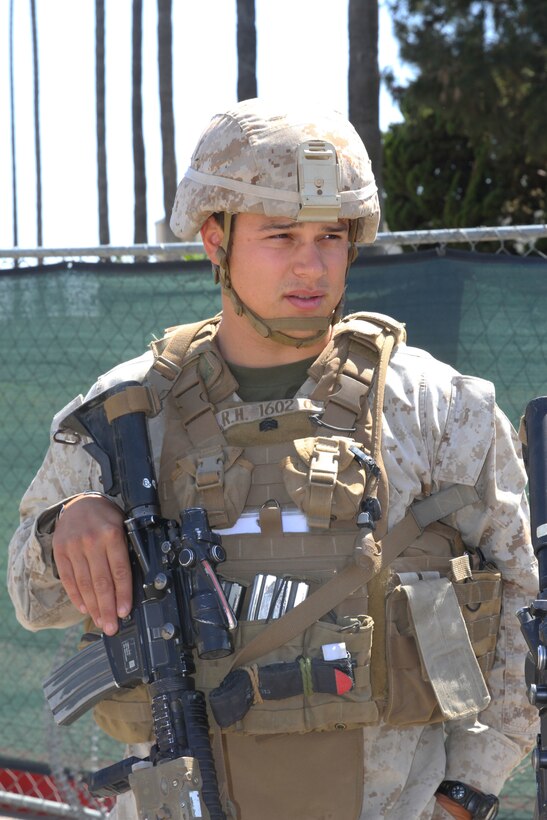 Sgt. Randall J. Hernandez, squad leader for Company I, 3rd Battalion, 1st Marine Regiment, speaks to Lance Cpl. Matthew F. Kathe, a rifleman for Company I while standing post aboard Joint Forces Training Base in Los Alamitos, Calif., April 13, 2015. The Marines of Company I were training for a scheduled deployment with the 15th Marine Expeditionary Unit in May.