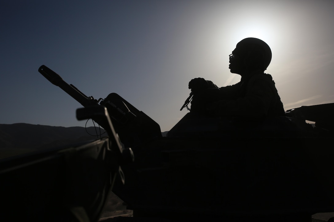 Sgt. Zarina I. Flemming, turret gunner, Amphibious Assault Vehicle Platoon, Company B, Ground Combat Element Integrated Task Force, sits atop an AAV en route to the Ammo Supply Point during a Marine Corps Operational Test and Evaluation Activity assessment, April 7, 2015. From October 2014 to July 2015, the GCEITF will conduct individual and collective level skills training in designated ground combat arms occupational specialties in order to facilitate the standards-based assessment of the physical performance of Marines in a simulated operating environment performing specific ground combat arms tasks. (U.S. Marine Corps photo by Sgt. Alicia R. Leaders/Released)