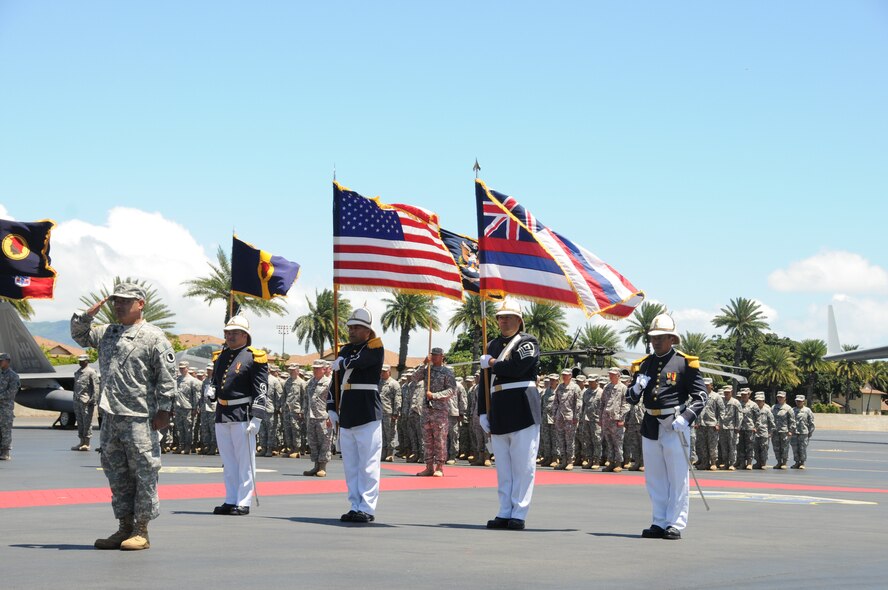 The Royal Guard of the Hawaii National Guard, led by Brig. Gen. Keith Y. Tamashiro, Hawaii Army National Guard, presents the colors during a retirement ceremony at the distinguished visitors reception area on Joint Base Pearl Harbor-Hickam, Hawaii, April 12, 2015. The Royal Guard was created in 1962 and is a Hawaii Air National Guard unit made up of native Hawaiians.(U.S. Air Force photo by Airman 1st Class Robert Cabuco/Released)

