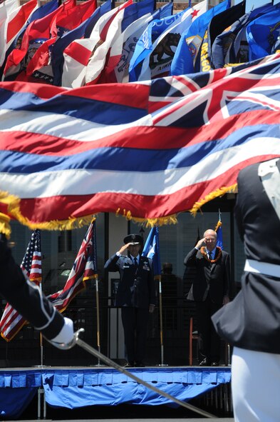 Maj. Gen. Darryll D.M. Wong, former Hawaii State adjutant general and Retired Gen. Craig McKinley, former chief, National Guard Bureau, salute the Hawaii state flag during a retirement ceremony at the Distinguished Visitors reception area on Joint Base Pearl Harbor-Hickam, Hawaii, April 12, 2015. The Royal Guard, consisting of members of the Hawaii Air National Guard, present the colors for the ceremony. (U.S. Air Force photo by Airman 1st Class Robert Cabuco/Released)

