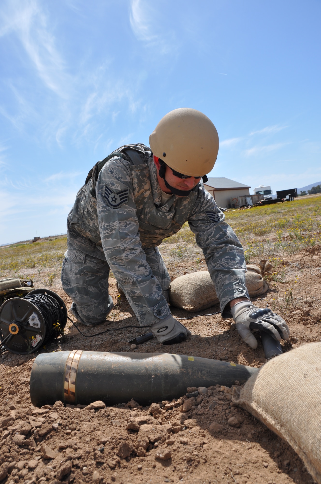 Staff Sgt. Robert Lopez, 944th Explosive Ordnance Disposal technician, hones his skills as he carefully evaluates and prepares a UXO for detonation during an exercise scenario held on the April UTA.  Originally from Hawaii Lopez is currently a fulltime student who spent time on active duty in the EOD career field before joining the 944th EOD Flight in 2012. 